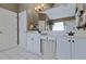 Bright bathroom with double sinks, white cabinets, and decorative fixtures at 1664 William Hapton Way, Mount Pleasant, SC 29466