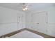 Minimalist bedroom featuring fresh white walls, double closets, and ceiling fan at 1664 William Hapton Way, Mount Pleasant, SC 29466
