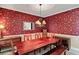 Well-lit dining room with a decorative wallpaper, hardwood floors, and a long wooden table at 1664 William Hapton Way, Mount Pleasant, SC 29466