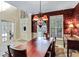Elegant dining room with wallpaper, hardwood floors, modern lighting, and a large wooden dining table at 1664 William Hapton Way, Mount Pleasant, SC 29466