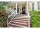 Inviting front porch with decorative flowers and classic architectural details at 1664 William Hapton Way, Mount Pleasant, SC 29466