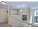 Bright hallway featuring white railings, pendant lighting, and photo gallery wall at 1664 William Hapton Way, Mount Pleasant, SC 29466