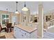 Kitchen view with island, white cabinets, tiled floors, stainless steel appliances and pendant lighting at 1664 William Hapton Way, Mount Pleasant, SC 29466
