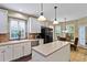 Bright kitchen with white cabinets, stainless steel appliances, tiled backsplash, and a center island at 1664 William Hapton Way, Mount Pleasant, SC 29466