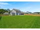 Expansive fenced backyard with lush green grass and professional landscaping surrounding the property at 1950 Parish House Cir, Johns Island, SC 29455