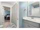 Bright bathroom featuring a gray vanity with a white countertop, a mirror, and floral shower curtain at 1950 Parish House Cir, Johns Island, SC 29455