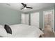Bright bedroom with light green walls, wood floors, and view of the ensuite bathroom at 1950 Parish House Cir, Johns Island, SC 29455