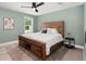 Cozy bedroom featuring a rustic wooden bed frame, soft bedding, and natural light from the window at 1950 Parish House Cir, Johns Island, SC 29455