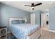 Comfortable bedroom with blue walls, wood floors, closet and ensuite bathroom access, and natural light at 1950 Parish House Cir, Johns Island, SC 29455