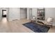 Inviting bonus room with light wood floors, a stylish rug, seating, and a built-in bookshelf at 1950 Parish House Cir, Johns Island, SC 29455