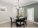 Bright dining area with a modern chandelier, round wood table and decorative centerpiece at 1950 Parish House Cir, Johns Island, SC 29455