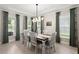 Elegant dining room with stylish chandelier, tray ceiling, and large windows at 1950 Parish House Cir, Johns Island, SC 29455