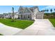 Charming gray home with an attached two-car garage and long driveway at 1950 Parish House Cir, Johns Island, SC 29455