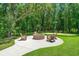 Inviting outdoor fire pit area with seating surrounded by beautiful trees at 1950 Parish House Cir, Johns Island, SC 29455