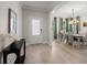 Bright foyer featuring light wood flooring, a decorative table, and an open view to the dining room at 1950 Parish House Cir, Johns Island, SC 29455
