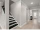 Bright hallway with hardwood floors and a staircase leading to the upper level at 1950 Parish House Cir, Johns Island, SC 29455