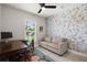 Bright home office with stylish floral wallpaper, desk, and comfortable sofa at 1950 Parish House Cir, Johns Island, SC 29455