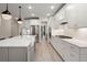 White kitchen features stainless steel appliances and a large center island with sink at 1950 Parish House Cir, Johns Island, SC 29455