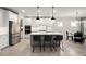 Well-lit kitchen with stainless steel fridge, double ovens, and seating at the center island at 1950 Parish House Cir, Johns Island, SC 29455