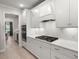 Modern kitchen with white cabinets, quartz counters, and a built-in gas cooktop at 1950 Parish House Cir, Johns Island, SC 29455