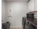 Functional laundry room equipped with modern washer and dryer units, white cabinets, and a laundry basket at 1950 Parish House Cir, Johns Island, SC 29455