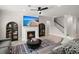 Inviting living room with fireplace, modern ceiling fan, and staircase, perfect for relaxation at 1950 Parish House Cir, Johns Island, SC 29455