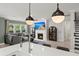 Stylish open-concept living room featuring a cozy fireplace and a view of the kitchen island at 1950 Parish House Cir, Johns Island, SC 29455