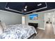 Comfortable main bedroom with tv and open doorway that shows a private sitting room at 1950 Parish House Cir, Johns Island, SC 29455