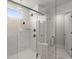 Shower featuring tiled walls, multiple shower heads and frameless glass door and side at 1950 Parish House Cir, Johns Island, SC 29455