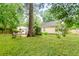 Expansive backyard with lush green grass and mature trees provides a private outdoor space at 202 Chandler Dr, Ladson, SC 29456