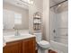 Cozy bathroom with oak cabinet, standard toilet, and a shower-tub combo at 202 Chandler Dr, Ladson, SC 29456