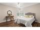 Nicely staged bedroom with wood floors, decorative console table and a stylish bed with patterned pillows at 202 Chandler Dr, Ladson, SC 29456