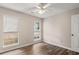 This cozy bedroom offers wood floors, a ceiling fan, and two windows for natural light at 202 Chandler Dr, Ladson, SC 29456
