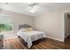 Neutral bedroom featuring a white bed with patterned pillows, a ceiling fan and natural light at 202 Chandler Dr, Ladson, SC 29456