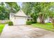 Charming one-story house showcasing a white garage door and a driveway with green surroundings at 202 Chandler Dr, Ladson, SC 29456