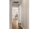 Hallway with wood floors leading to table with decor at 202 Chandler Dr, Ladson, SC 29456