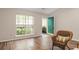 Inviting living room featuring a wicker chair and ample natural light, creating a warm and comfortable space at 202 Chandler Dr, Ladson, SC 29456