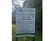 Sign details the Pine Trace Natural Area Development, including trails, disc golf, playground, kayaking, and fishing at 202 Chandler Dr, Ladson, SC 29456