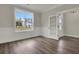 Living room featuring a large window, wood floors, and a paneled accent wall at 2020 Grange Cir, Summerville, SC 29486