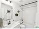 Well-lit bathroom features a white vanity, decorative mirror, and tiled shower and tub at 2050 Mcguire Ln # 13, Hollywood, SC 29449