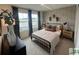 Bedroom with a decorative wall, a bed with pillows, and a large window view at 2050 Mcguire Ln # 13, Hollywood, SC 29449