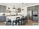 Stylish kitchen featuring gray cabinets, stainless steel appliances, a center island, and modern pendant lighting at 2050 Mcguire Ln # 13, Hollywood, SC 29449