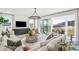 Bright living room featuring a fireplace, large couch, outdoor patio, and nature views at 2050 Mcguire Ln # 13, Hollywood, SC 29449
