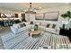Spacious living room with modern decor, rug, large couch, pendant lighting, and kitchen view at 2050 Mcguire Ln # 13, Hollywood, SC 29449