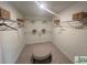 Spacious walk-in closet with shelving, garment rods, and a center ottoman at 2050 Mcguire Ln # 13, Hollywood, SC 29449