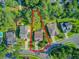 Aerial view of home with marked boundary lines, lush trees, a long driveway, and an attached garage at 206 President Cir, Summerville, SC 29483