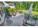 Landscaped backyard featuring a well-manicured lawn, patio, outdoor seating, and lush garden at 206 President Cir, Summerville, SC 29483