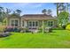 Backyard with lush green lawn, patio, and well-maintained landscaping around the home at 206 President Cir, Summerville, SC 29483
