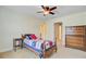 Bright bedroom featuring a ceiling fan, baseball themed comforter, side table, and wooden dresser at 206 President Cir, Summerville, SC 29483