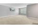 Upstairs bonus room with natural light, neutral carpet and a TV at 206 President Cir, Summerville, SC 29483